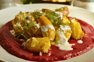 Smashed Potatoes Served With Beetroot Chickpea Puree