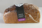 A loaf of gluten-free bread wrapped in clear plastic packaging with a black and purple label. The label reads 'Bountiful Blessings Bakery' and 'Gluten Free'.